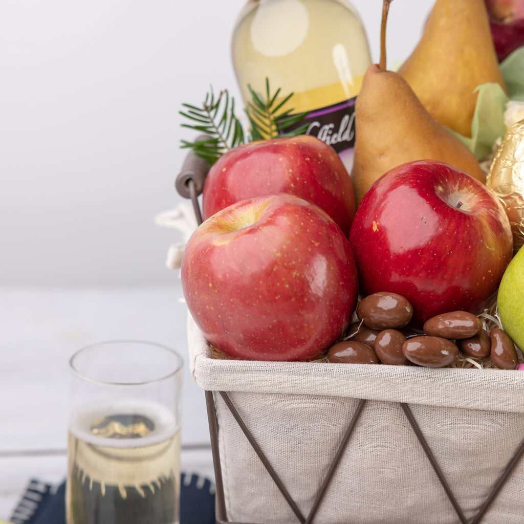 Glossy red apples on a bed of chocolate covered nuts