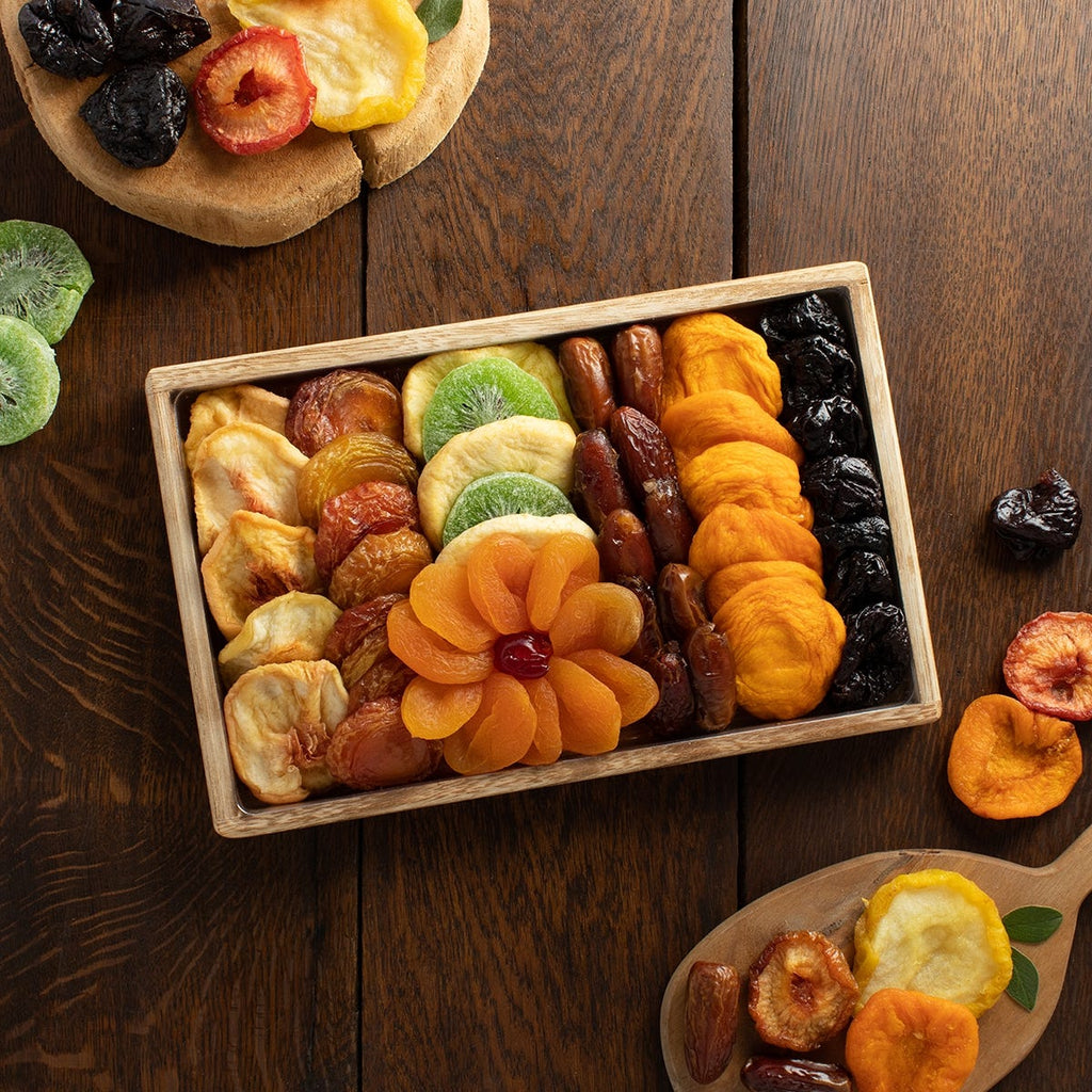 8 types dried fruits beautifully arranged in a square wooden tray