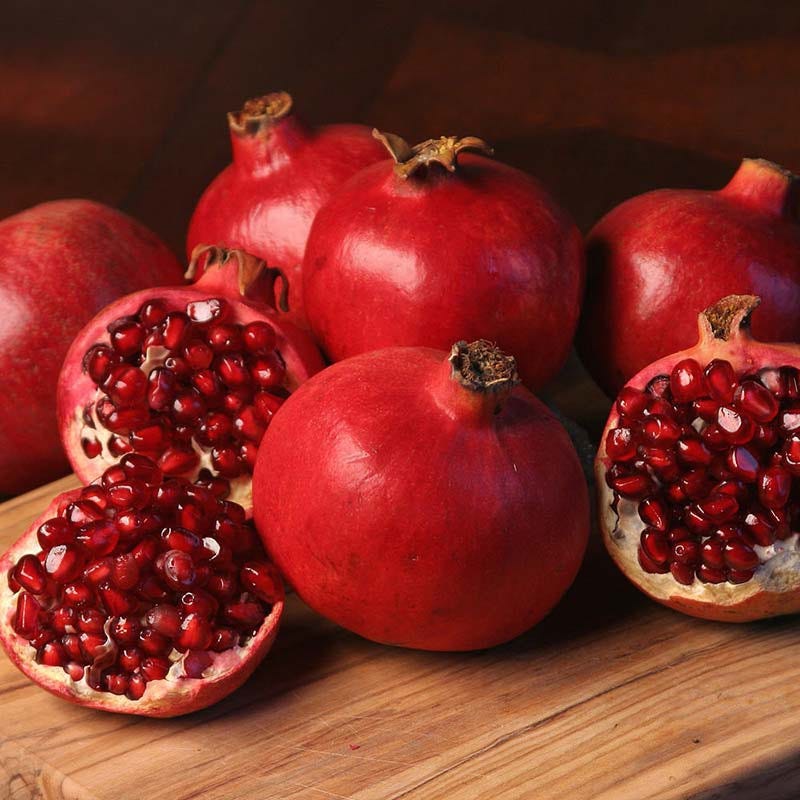 Juicy pomegranates with delicious seeds exposed Vibrant, juicy pomegranate with sweet-tart flavor